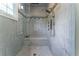 Modern shower stall featuring marble-style tiling, a glass enclosure, and a built-in bench at 8470 Lazy Oaks Ct, Atlanta, GA 30350