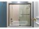 Bathroom features a shower with glass doors and tile walls at 8470 Lazy Oaks Ct, Atlanta, GA 30350
