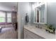 Bright bathroom with a vanity, mirror, and natural light flowing from the room beyond at 8470 Lazy Oaks Ct, Atlanta, GA 30350