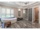 Open bathroom design showcasing a freestanding tub, glass shower, and stylish marble floors at 8470 Lazy Oaks Ct, Atlanta, GA 30350
