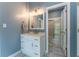 Bathroom features a vanity with marble floors and a shower with glass door at 8470 Lazy Oaks Ct, Atlanta, GA 30350