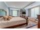 Spacious primary bedroom with large windows, hardwood floors and ensuite bath at 8470 Lazy Oaks Ct, Atlanta, GA 30350