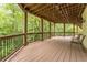 This lovely covered deck features natural views and railing detail, perfect for enjoying the outdoors at 8470 Lazy Oaks Ct, Atlanta, GA 30350