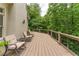 Enjoy the outdoors from this deck with multiple seating options perfect for relaxing and enjoying the wooded view at 8470 Lazy Oaks Ct, Atlanta, GA 30350