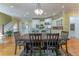 Formal dining room with elegant wood table and chairs, seamlessly connected to the kitchen and living areas at 8470 Lazy Oaks Ct, Atlanta, GA 30350