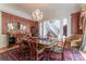 Dining room with hardwood floors, crystal chandelier, and access to the main staircase at 8470 Lazy Oaks Ct, Atlanta, GA 30350