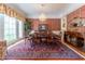 Formal dining room with a crystal chandelier, elegant wallpaper, and large windows providing natural light at 8470 Lazy Oaks Ct, Atlanta, GA 30350