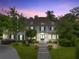 Elegant two-story home with a well-manicured lawn, stone pathway, and a symmetrical facade at 8470 Lazy Oaks Ct, Atlanta, GA 30350