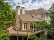 Multi-level back deck showcasing an elegant home exterior with well-manicured landscaping at 8470 Lazy Oaks Ct, Atlanta, GA 30350