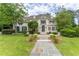 Charming two-story home with a well-manicured lawn and beautiful stone pathway leading to the entrance at 8470 Lazy Oaks Ct, Atlanta, GA 30350
