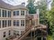 Expansive home exterior featuring multiple decks and levels perfect for outdoor living and entertaining at 8470 Lazy Oaks Ct, Atlanta, GA 30350