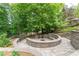 This beautiful stone fire pit is perfect for entertaining and enjoying the outdoors at 8470 Lazy Oaks Ct, Atlanta, GA 30350