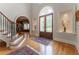 Grand foyer features beautiful glass doors, hardwood floors, and staircase at 8470 Lazy Oaks Ct, Atlanta, GA 30350