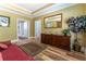 Bright foyer featuring a hardwood floor, buffet, ornate mirror, and a houseplant at 8470 Lazy Oaks Ct, Atlanta, GA 30350