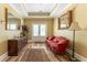 Light-filled foyer with hardwood floors, red sofa, decorative mirror, and a plant at 8470 Lazy Oaks Ct, Atlanta, GA 30350