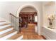 Hallway with hardwood floors and archway leading to a wood-paneled office at 8470 Lazy Oaks Ct, Atlanta, GA 30350