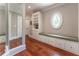 Bright hallway featuring hardwood floors, built in shelves, and a large oval window at 8470 Lazy Oaks Ct, Atlanta, GA 30350