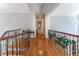 Elegant hallway features hardwood floors, decorative railing at 8470 Lazy Oaks Ct, Atlanta, GA 30350
