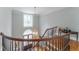 Elegant upstairs hallway with decorative railing and bright window at 8470 Lazy Oaks Ct, Atlanta, GA 30350