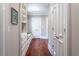 Hallway with built in shelves and drawers with an olive green bench seat and hardwood floors at 8470 Lazy Oaks Ct, Atlanta, GA 30350