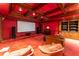 Home theater with a large screen, red color scheme, and comfortable seating at 8470 Lazy Oaks Ct, Atlanta, GA 30350