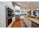 Gourmet kitchen boasts stainless steel appliances, granite countertops, and custom white cabinetry at 8470 Lazy Oaks Ct, Atlanta, GA 30350
