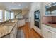 Spacious kitchen features granite countertops, stainless steel appliances, a double oven, and hardwood floors at 8470 Lazy Oaks Ct, Atlanta, GA 30350