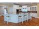 Well-appointed kitchen with white cabinetry, granite countertops, and a spacious breakfast bar with seating at 8470 Lazy Oaks Ct, Atlanta, GA 30350