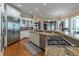 Open kitchen with granite countertops, gas cooktop, stainless steel appliances, and hardwood floors at 8470 Lazy Oaks Ct, Atlanta, GA 30350