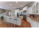 Bright kitchen features white cabinetry, granite countertops, stainless steel appliances and hardwood floors at 8470 Lazy Oaks Ct, Atlanta, GA 30350