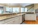 The kitchen has granite counters, stainless appliances, an island with seating and a gas cooktop at 8470 Lazy Oaks Ct, Atlanta, GA 30350