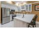 Basement kitchenette with stainless steel appliances, white cabinets, and bar stool seating at 8470 Lazy Oaks Ct, Atlanta, GA 30350