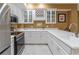 Basement kitchenette with stainless steel appliances, white cabinets, and a wine rack at 8470 Lazy Oaks Ct, Atlanta, GA 30350
