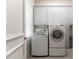 Functional laundry room with modern washer and dryer and ample storage cabinetry at 8470 Lazy Oaks Ct, Atlanta, GA 30350
