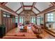 Inviting living room with stone fireplace, wood floors, large windows, and built-in cabinets at 8470 Lazy Oaks Ct, Atlanta, GA 30350