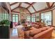 Comfortable living room featuring a stone fireplace, beamed ceilings, and hardwood flooring at 8470 Lazy Oaks Ct, Atlanta, GA 30350