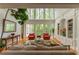 Bright and airy living room with soaring ceilings, large windows, and custom built-in shelving at 8470 Lazy Oaks Ct, Atlanta, GA 30350
