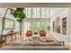 Bright living room with tall windows and hardwood floors at 8470 Lazy Oaks Ct, Atlanta, GA 30350