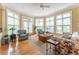 Sunroom with lots of windows offering great natural light and comfortable seating arrangements at 8470 Lazy Oaks Ct, Atlanta, GA 30350