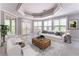 Bright living room with neutral tones, tray ceiling, and large windows providing ample natural light at 8470 Lazy Oaks Ct, Atlanta, GA 30350