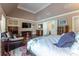 Spacious bedroom boasts a cozy sitting area, hardwood floors, and tray ceilings, creating a luxurious retreat at 8470 Lazy Oaks Ct, Atlanta, GA 30350