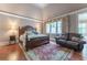 Main bedroom features a sitting area, hardwood floors, large window, and ensuite bathroom at 8470 Lazy Oaks Ct, Atlanta, GA 30350