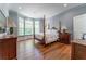 Main bedroom features bay windows, hardwood floors, and traditional-style furniture at 8470 Lazy Oaks Ct, Atlanta, GA 30350