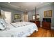 Bright main bedroom with hardwood floors, a four-poster bed, and ample natural light at 8470 Lazy Oaks Ct, Atlanta, GA 30350