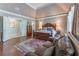 Main bedroom with sitting area, tray ceiling, and hardwood floors at 8470 Lazy Oaks Ct, Atlanta, GA 30350
