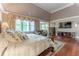 Bright bedroom featuring hardwood floors, large windows with elegant drapery, and a comfortable sitting area at 8470 Lazy Oaks Ct, Atlanta, GA 30350