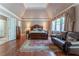 Main bedroom with hardwood floors, sitting area, large window, and ensuite bathroom access at 8470 Lazy Oaks Ct, Atlanta, GA 30350