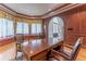 Wood paneled office with built-in window seat, hardwood floors, and furniture at 8470 Lazy Oaks Ct, Atlanta, GA 30350