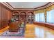 Sophisticated home office with custom wood paneling, built-in bookshelves, and a cozy window seat at 8470 Lazy Oaks Ct, Atlanta, GA 30350