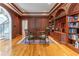 Office features beautiful built-in bookshelves, wood paneling, and hardwood floors at 8470 Lazy Oaks Ct, Atlanta, GA 30350